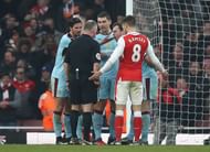 LONDON, ENGLAND - JANUARY 22:  Referee Jonathan Moss is surrounded by Burnley players after awarding a penalty to Arsenal after Laurent Koscielny of Arsenal challenged by Ben Mee of Burnley during the Premier League match between Arsenal and Burnley at the Emirates Stadium on January 22, 2017 in London, England.  (Photo by Julian Finney/Getty Images)